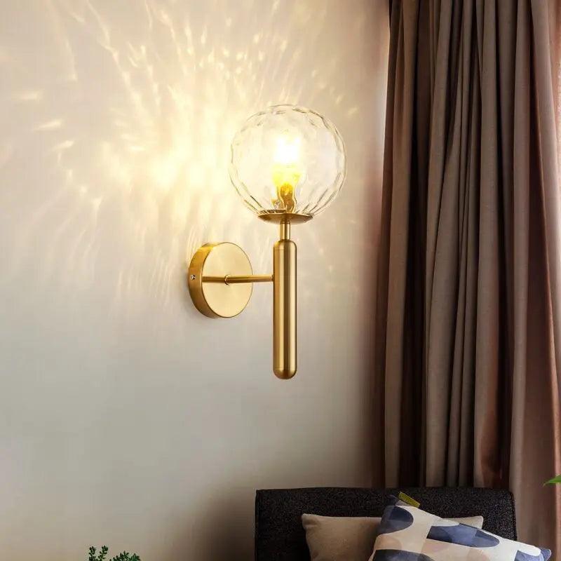 Aurelis – Gold Metal Wall Sconce with Glass Shade