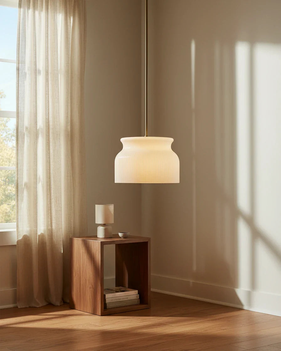 Aureline luxe gold ribbed glass pendant. Lit. In a kitchen setting.