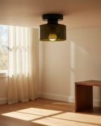 Aurelis round glass plafond in warm orange, flush mounted on a white ceiling, softly lit - Dark Green