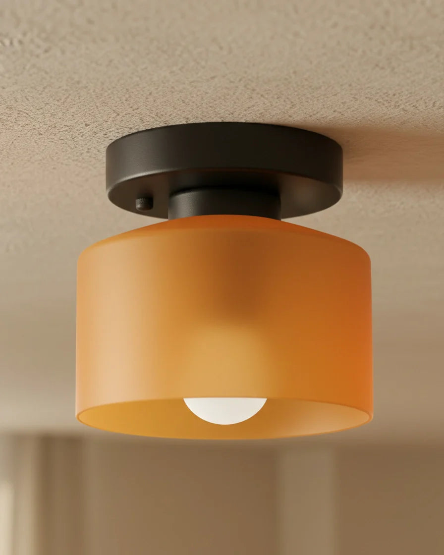 Aurelis round glass plafond in warm orange, flush mounted on a white ceiling, softly lit - detail 1