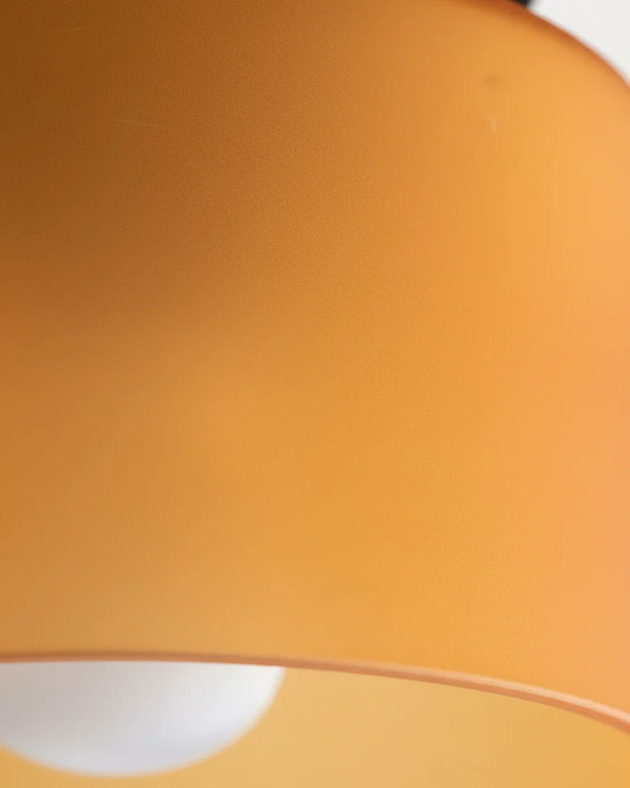 Aurelis round glass plafond in warm orange, flush mounted on a white ceiling, softly lit - detail 2