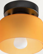 Aurelis round glass plafond in warm orange, flush mounted on a white ceiling, softly lit - detail 3