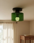 Aurelis round glass plafond in warm orange, flush mounted on a white ceiling, softly lit - Olive Green