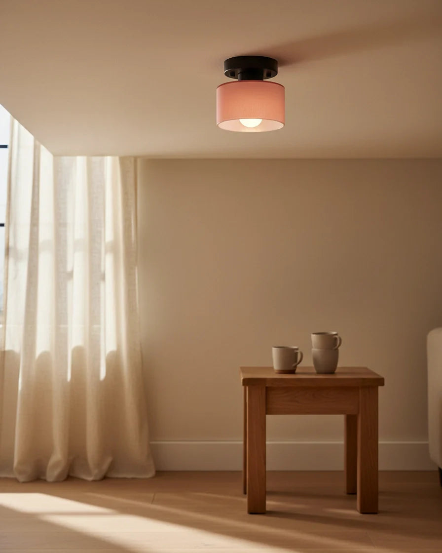 Aurelis round glass plafond in warm orange, flush mounted on a white ceiling, softly lit - Pink