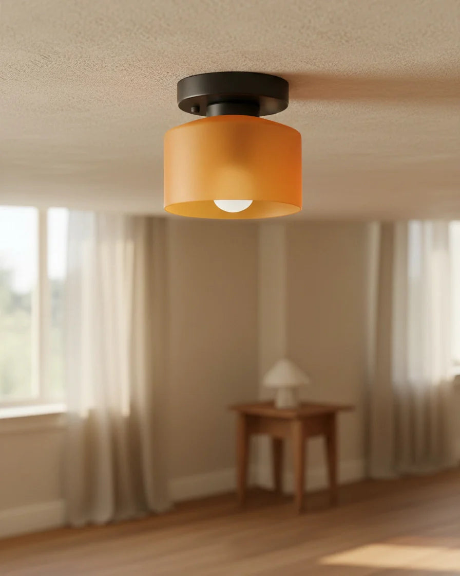 Aurelis round glass plafond in warm orange, flush mounted on a white ceiling, softly lit