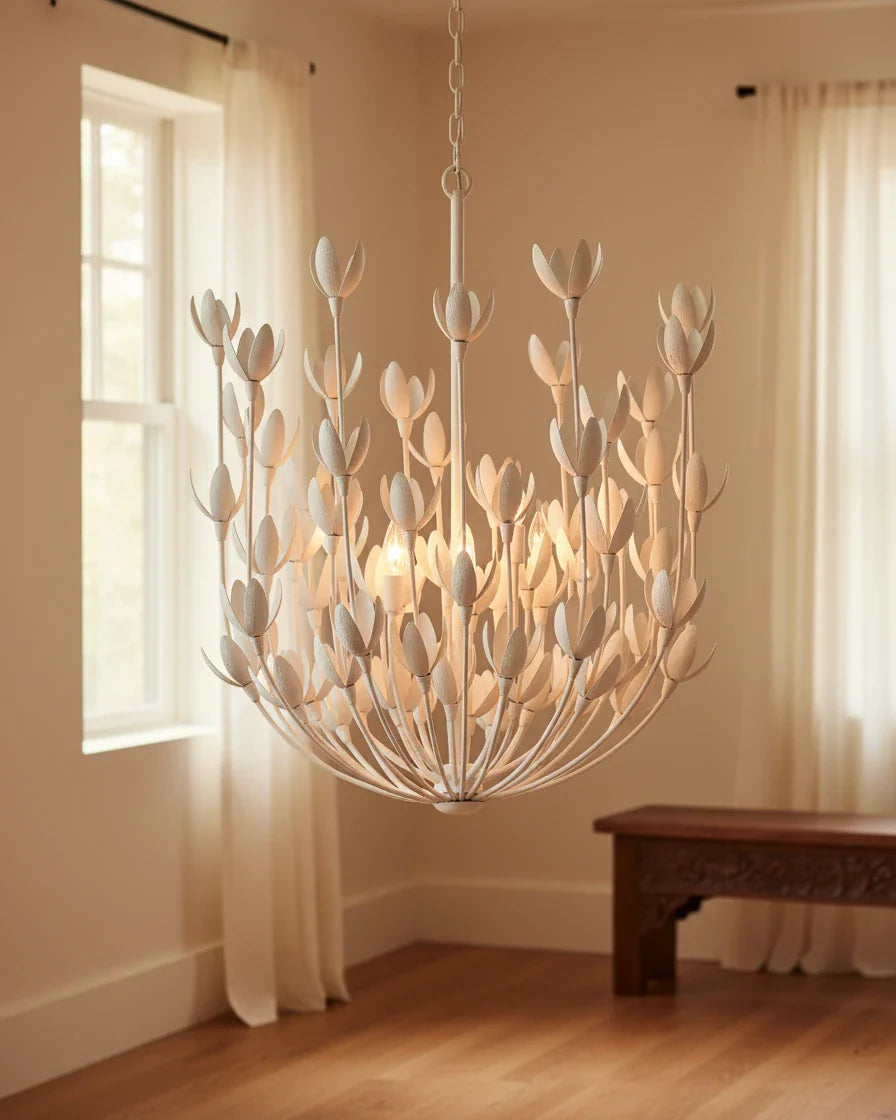Aurelis tiered petal chandelier in burnished gold, lit, hanging in a living room - Plaster White