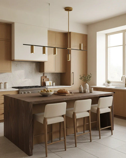 Modern linear island pendant with cylindrical gold and black shades on a horizontal bar, lit over a marble counter. - hero 2